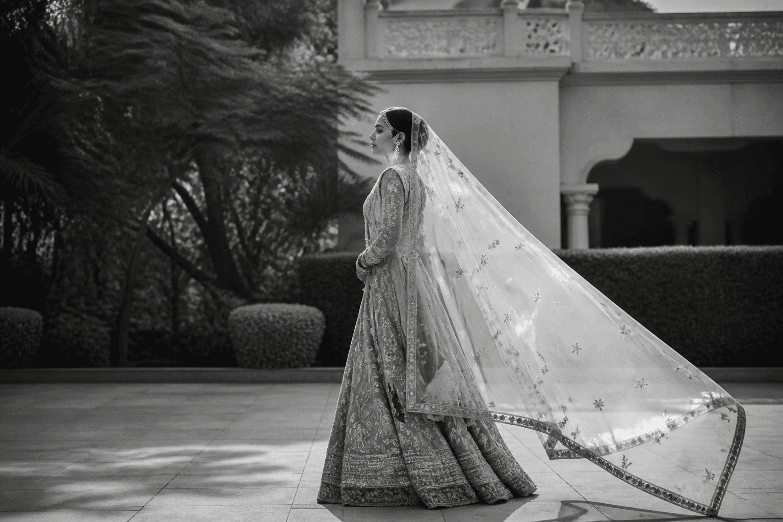 Bride walking through a garden